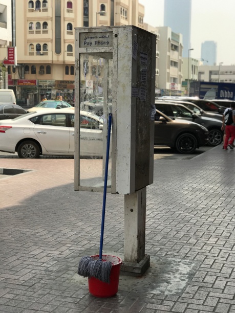 There are still phone booths in Satwa, an old part of Dubai. Great place to rest a mop, I suppose...